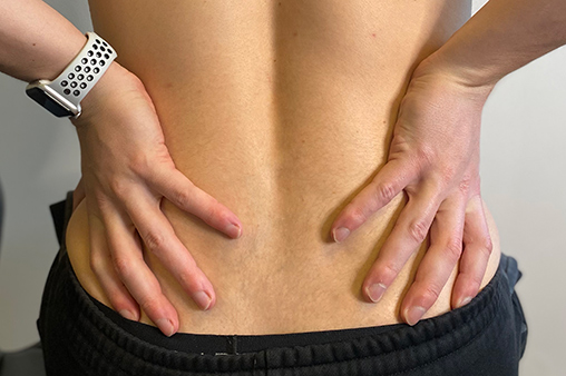 Hands on the lower back feeling pain